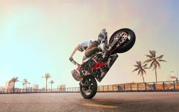 Free photo moto rider making a stunt on his motorbike biker doing a difficult and dangerous stunt