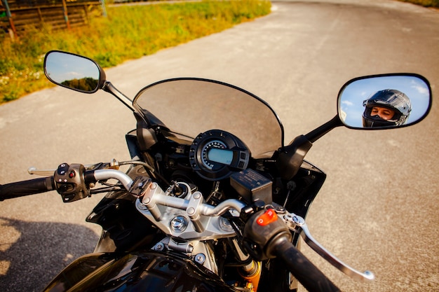Motorbike grips with rearview mirrors view of the biker