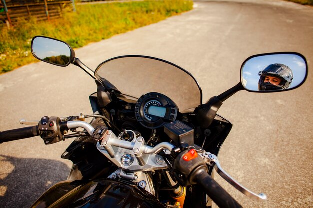 Motorbike grips with rearview mirrors view of the biker