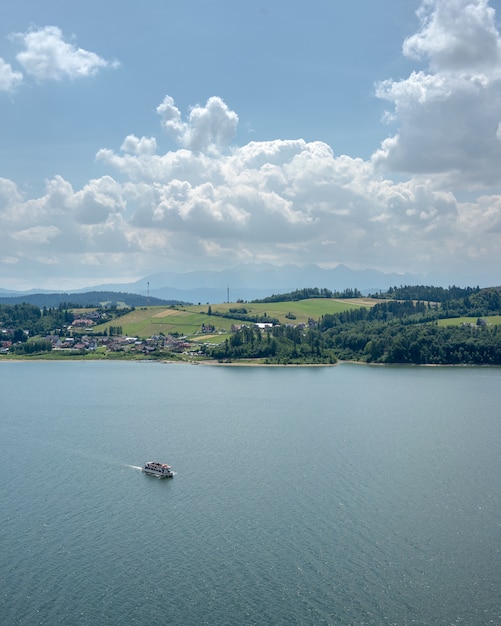 Motorboat in the sea with a green landscape on the coast