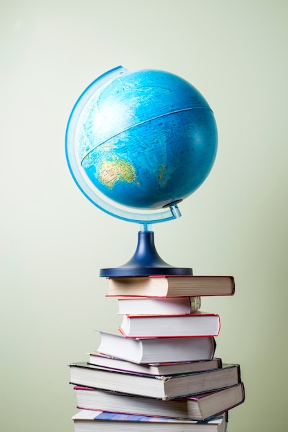 Mountain of books with a globe