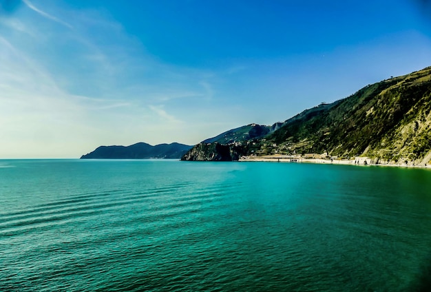 Mountain in front of the water in Italy