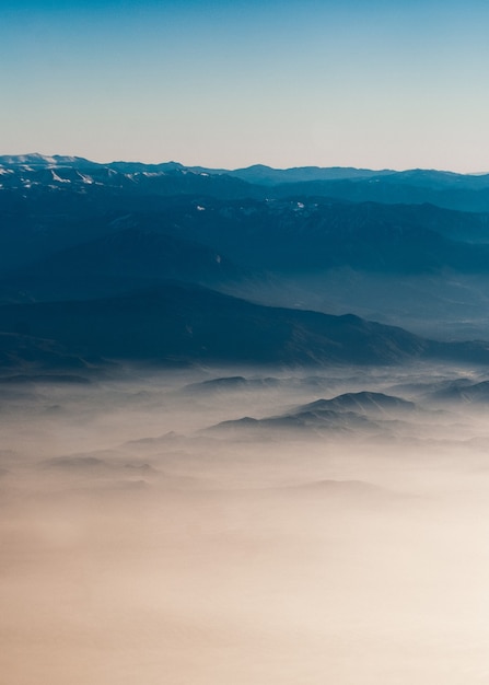 Exploring the Beauty of Mountain Ranges: Mesmerizing Silhouettes Amidst Colorful Morning Fog