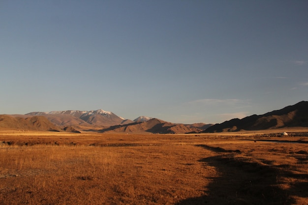 Mountainous landscape with dry grass and rocky hills