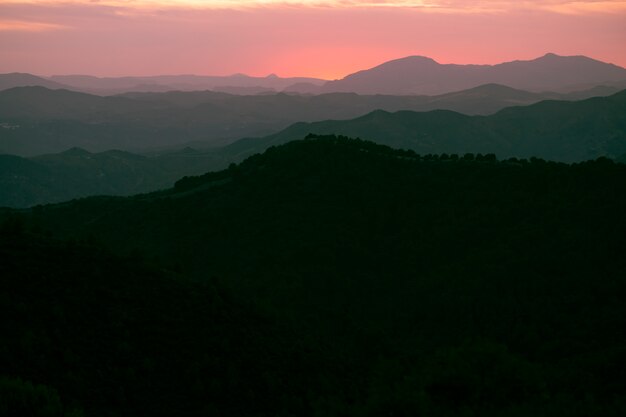 Mountains in black with pink sky