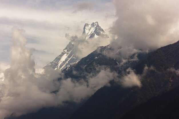 Mountains covered with snow and a foggy sky