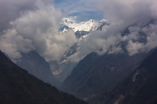 Mountains covered with snow and a foggy sky