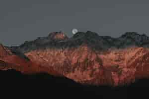 Free photo mountains behind fullmoon