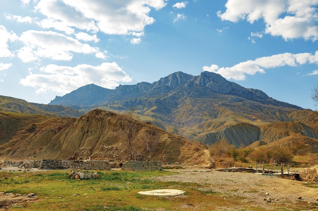 Mountains landscape against blue sky with clouds on sunny day