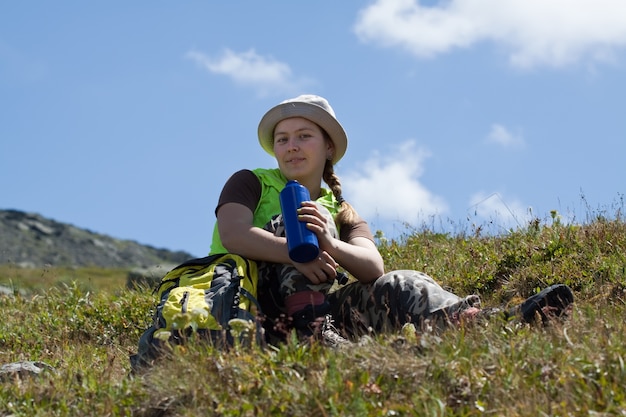 mountains tourist drinking  from bottle