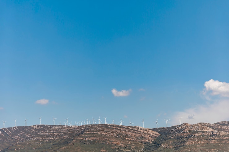 Free Photo mountains with windmills under blue sky 