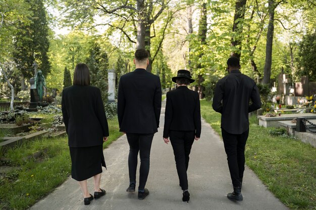 mourning family dressed in black visiting the cemetery