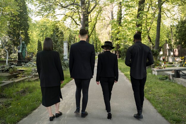 Mourning family dressed in black visiting the cemetery