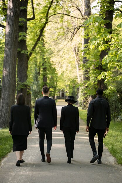 Mourning family dressed in black visiting the cemetery