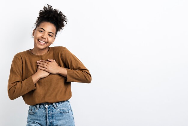 Moved woman posing with hands on chest