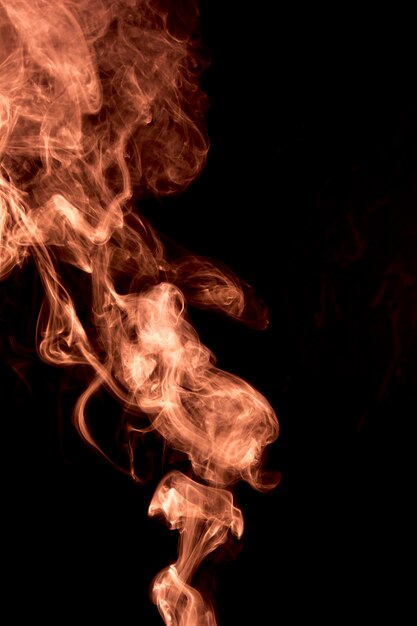Movement of dense fiery smoke on black background
