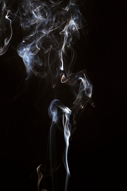 Movement of faded smoke on black background