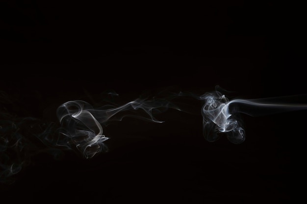 Movement of white smoke on black background