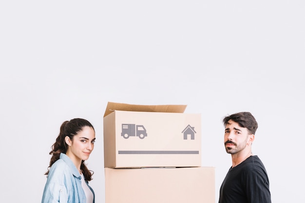 Free photo moving concept with couple next to boxes