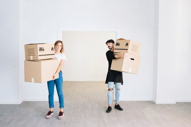 Moving concept with couple holding boxes