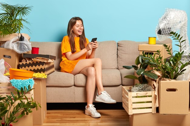 Moving in new house. Joyful pretty European woman rejoices buying expensive flat