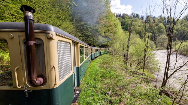 Moving steam train Mocanita with passengers in Romania