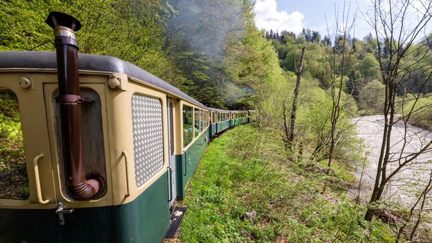 Moving steam train Mocanita with passengers in Romania