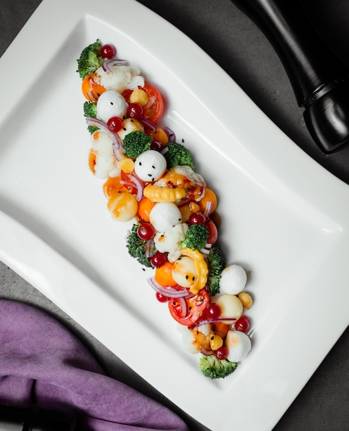 Mozarella cheese with cherry tomatoes and herbs.