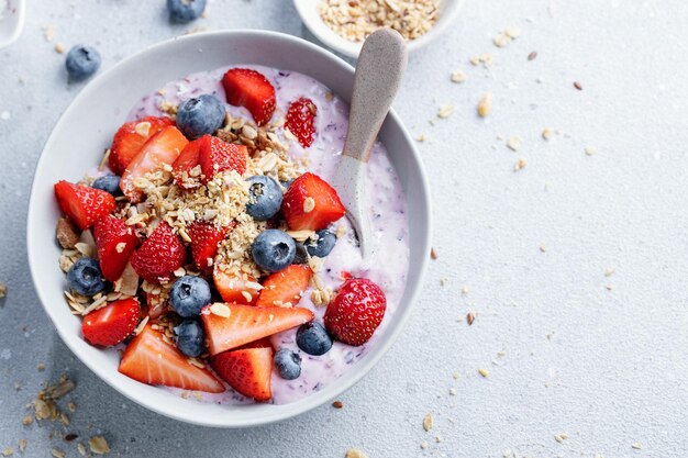 Muesli with fruits served in bowl on bright background Healthy eating concept