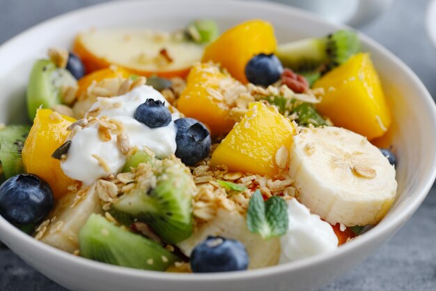 Muesli with fruits served in bowl