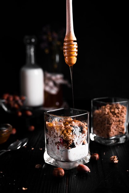 Muesli with honey and black background