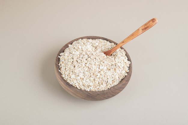 Muesli in a wooden cup on a concrete.