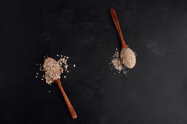 Mueslies in wooden spoons, top view. 