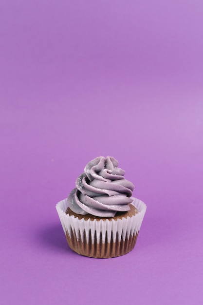 Muffin on violet background