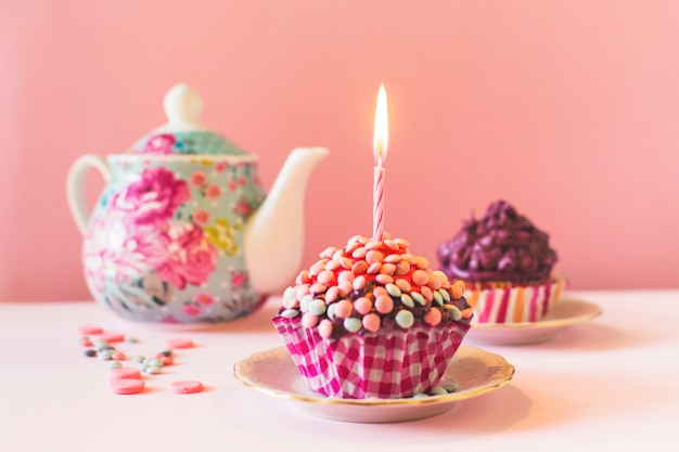 Muffins with illuminated candle on birthday