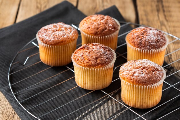 Muffins with powdered sugar on tray