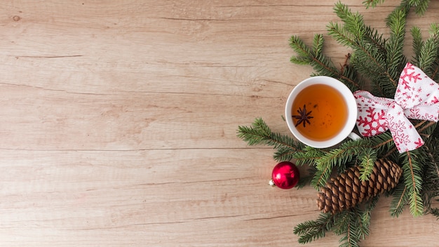 Free photo mug of drink near coniferous twigs and snags