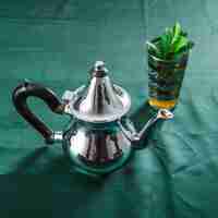 Free photo mug of drink and silver teapot