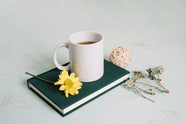 Mug and flower on notebook