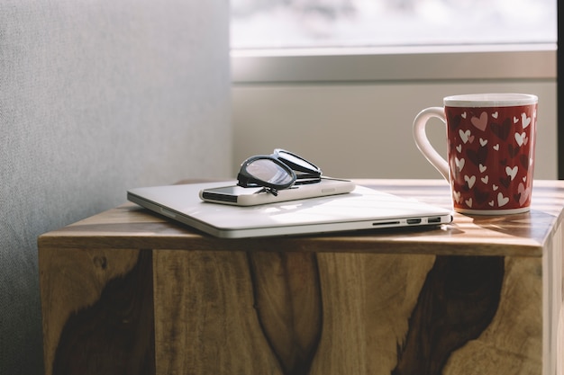 Mug and glasses near gadgets