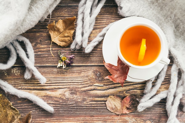 Mug of tea and scarf on table