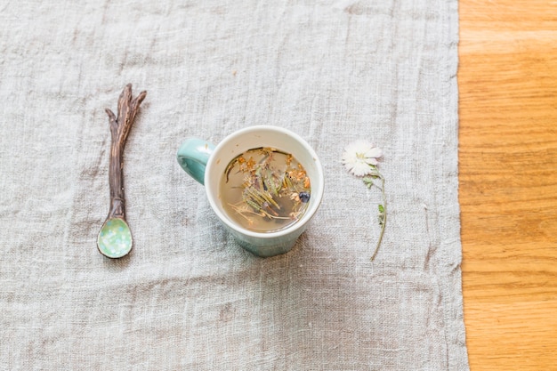 Mug with herbal infusion on table