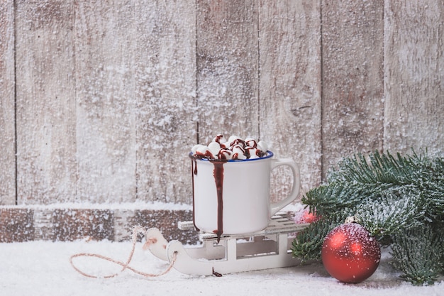 Mug with marshmallows and christmas decorations