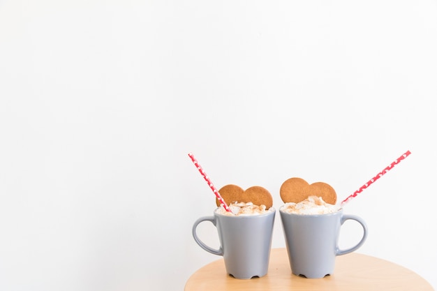 Mugs with coffee and cookies