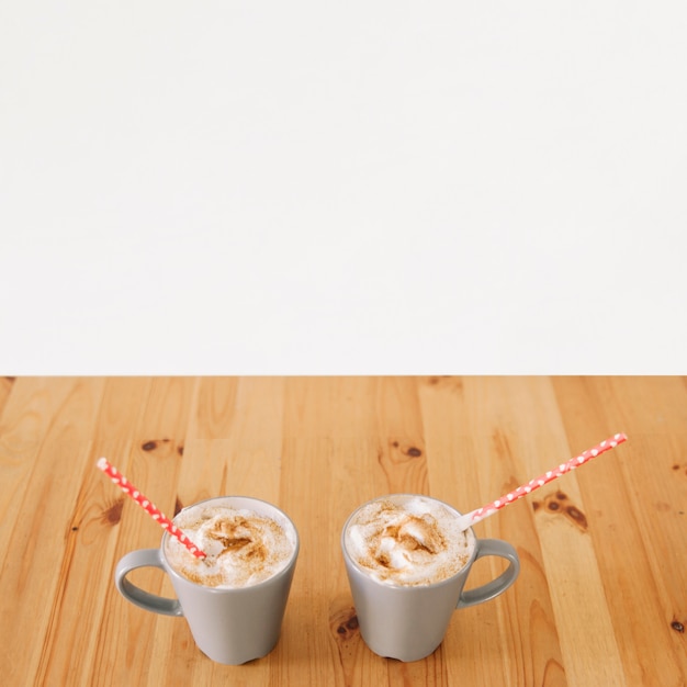 Free photo mugs with coffee and straws