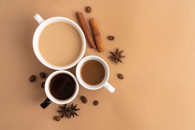 Mugs with coffee with cinnamon and anise beside