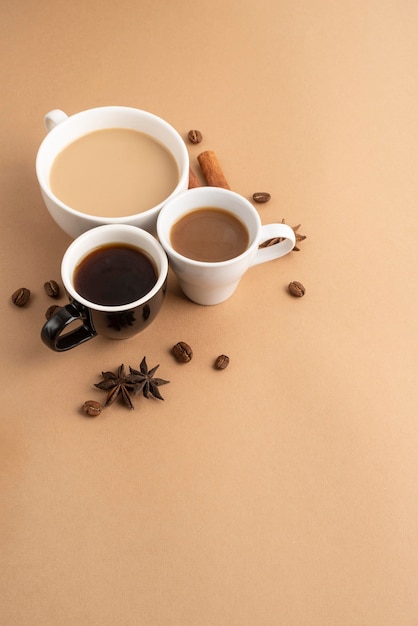 Mugs with coffee with cinnamon and anise beside