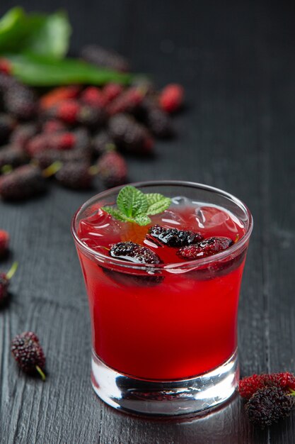 Mulberry juice on dark wooden surface