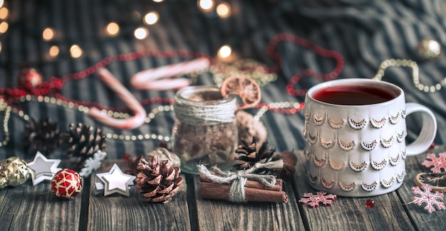 Mulled wine in a cup on a wooden background