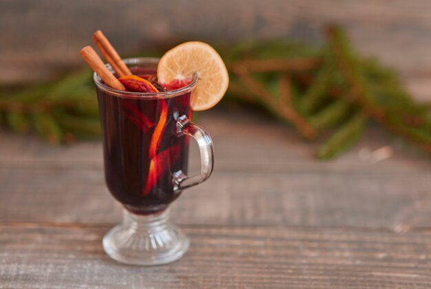 Mulled wine with cinnamon stick and lemon